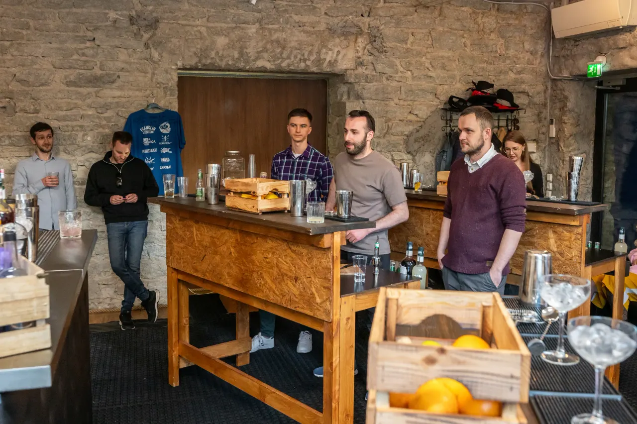 Five participants behind the counter at the start of the session
