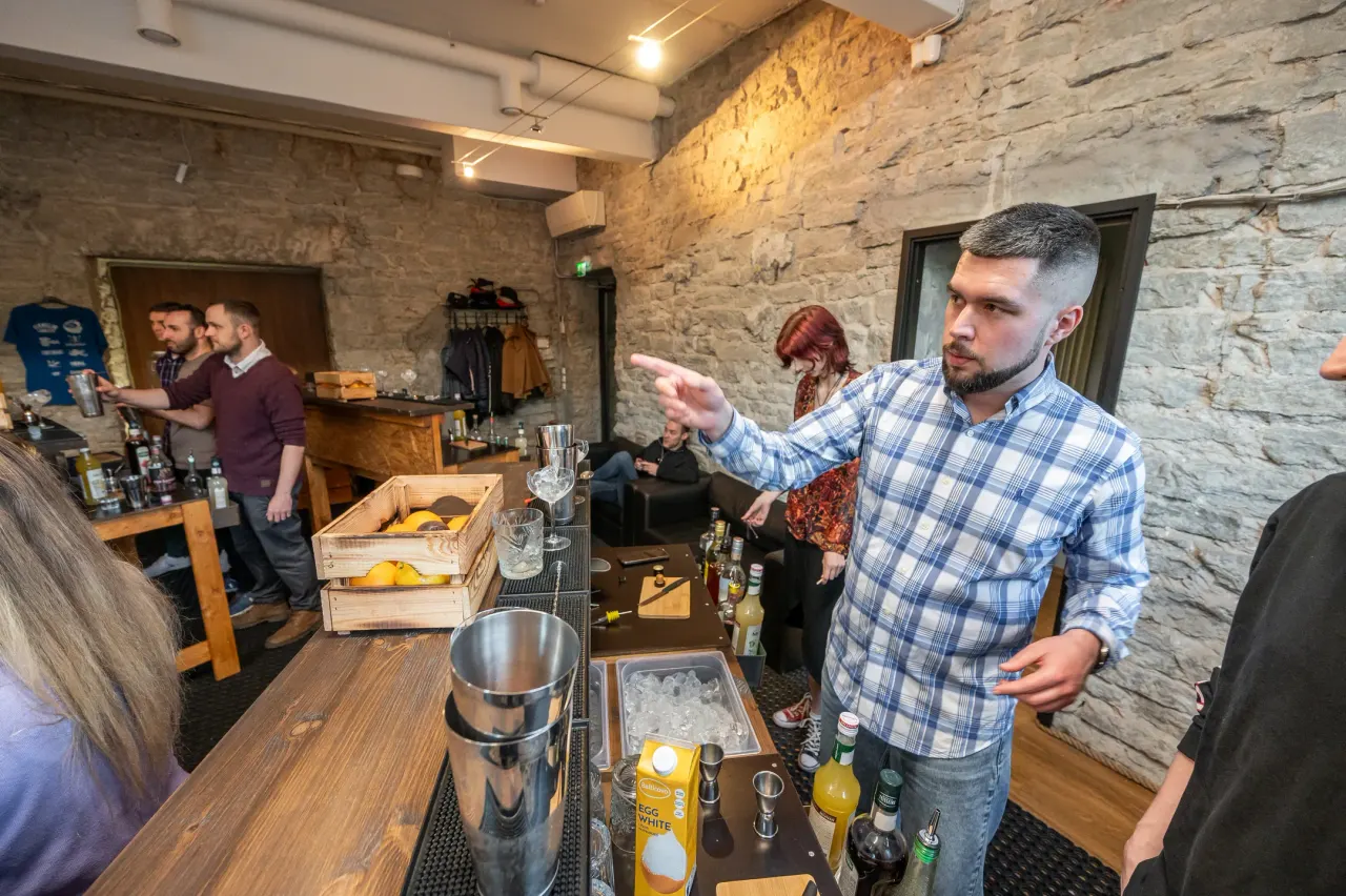 The instructor explaining the next step to students behind the counter