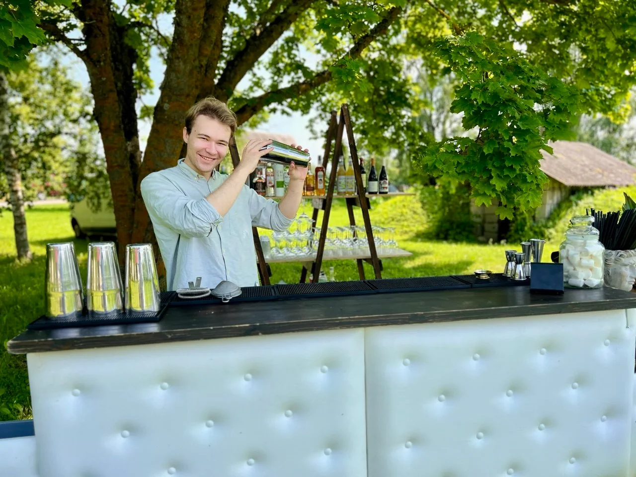 The white counter under a tree in a park at a summer event