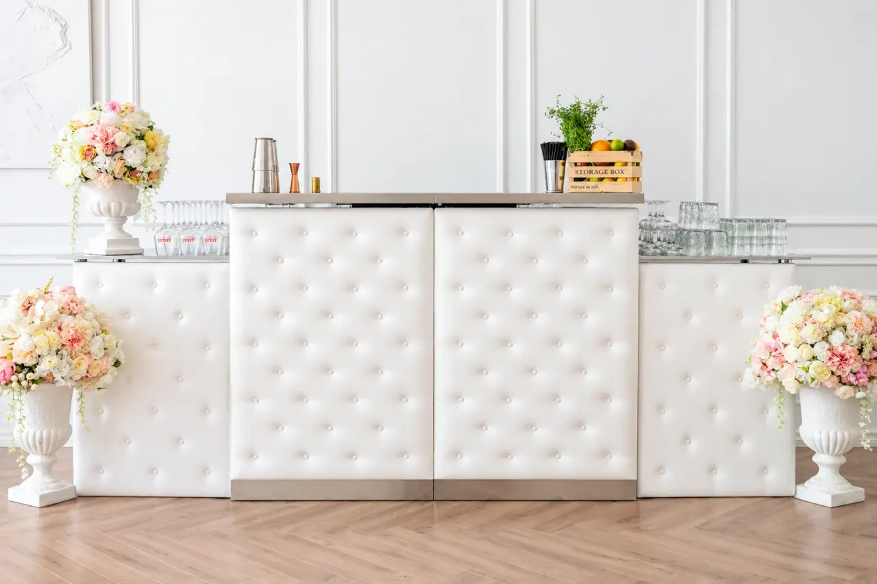 White upholstered Bartender’s bar counter in a bright room — the same counter in a different finish